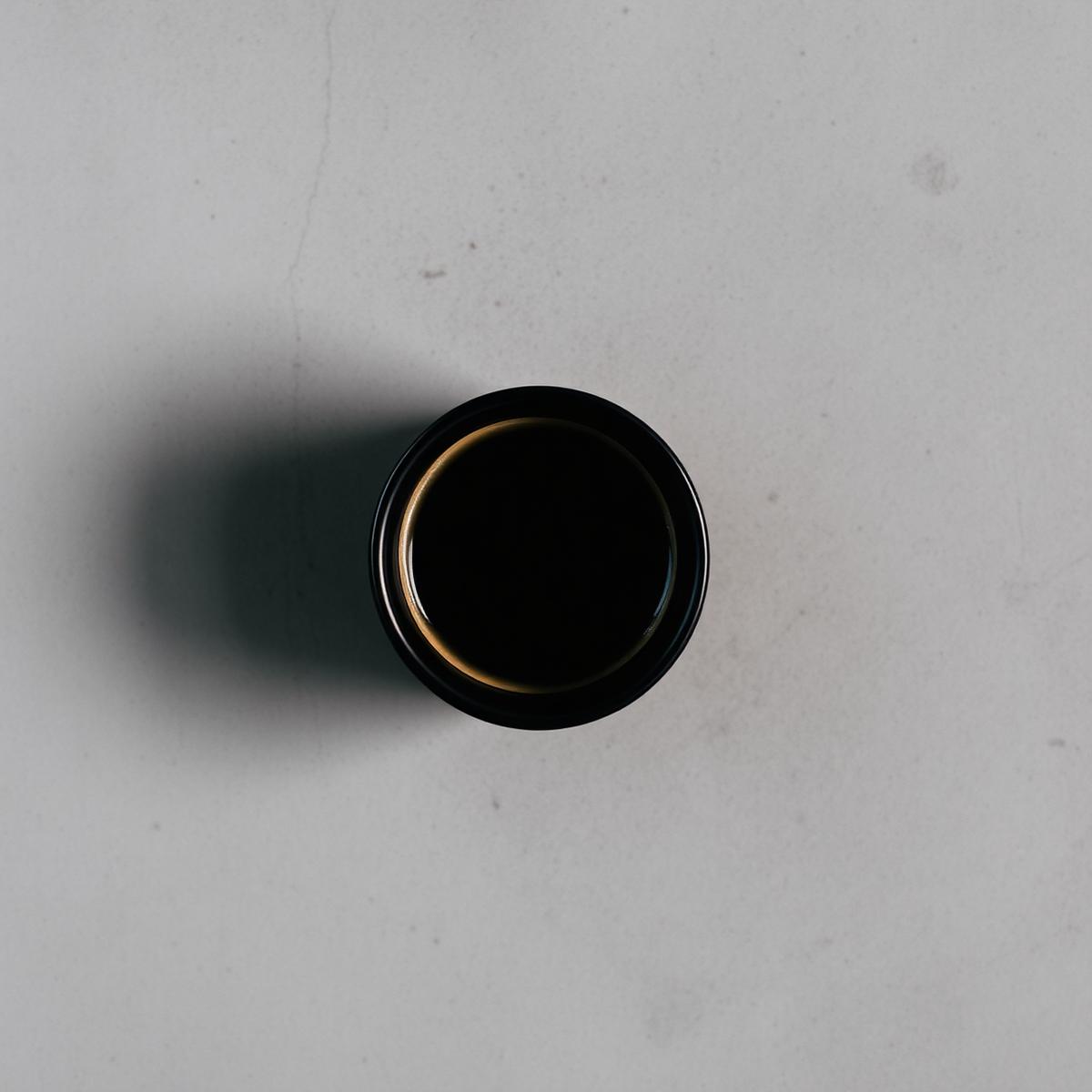Overhead shot of espresso in a black ceramic cup